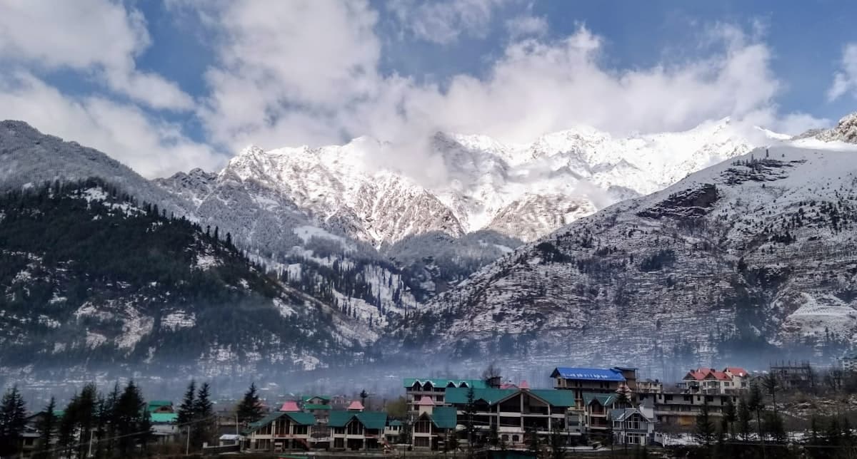 Snow-covered Himalayan peaks rising above Manali town in Himachal Pradesh